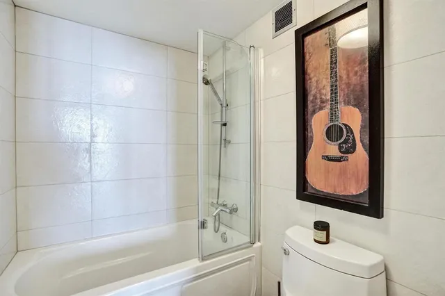 a kitchen with white cabinets and chairs