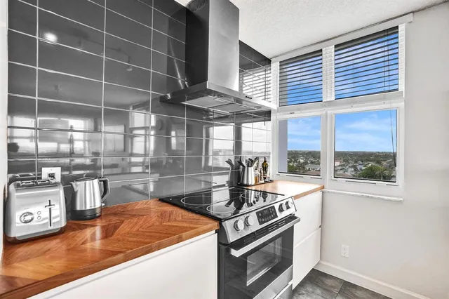 a kitchen with stainless steel appliances granite countertop a refrigerator and a stove