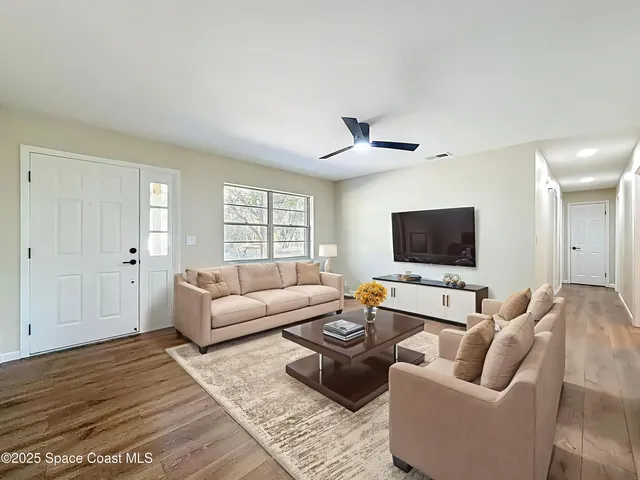 a kitchen with granite countertop white cabinets and stainless steel appliances