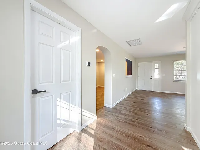 a kitchen with stainless steel appliances granite countertop white cabinets a stove a sink and dishwasher