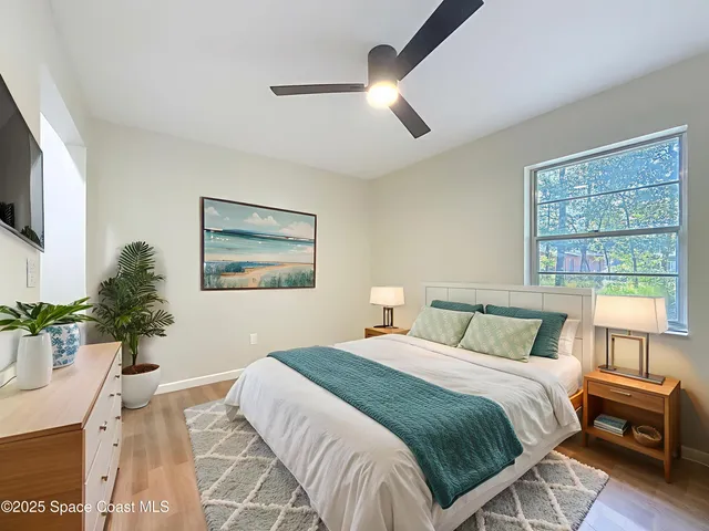 a view of a room with wooden floor and window