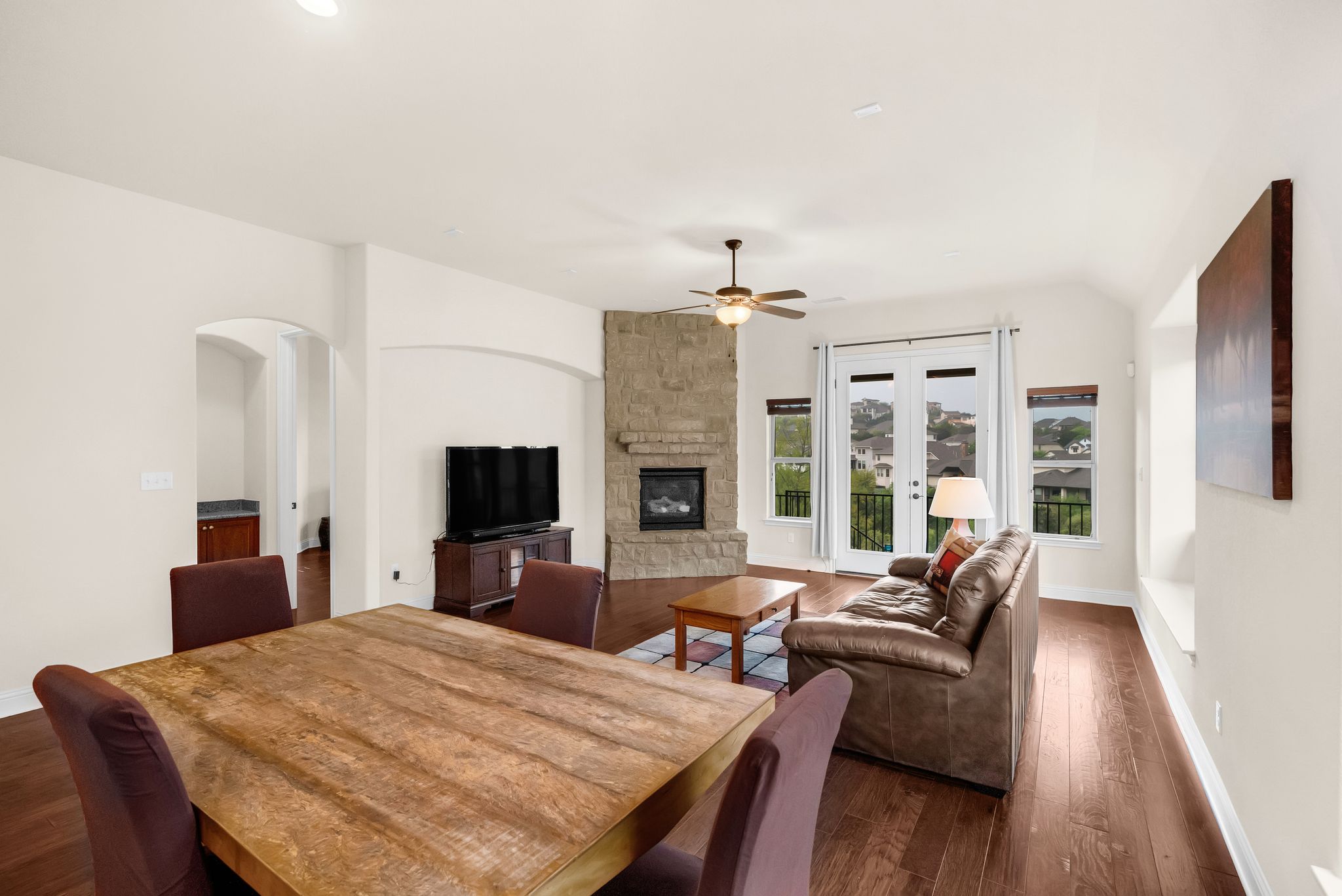 212 Tavish Trail Austin, TX 78738 - Photo 11 of 32 a living room with furniture a fireplace and a flat screen tv