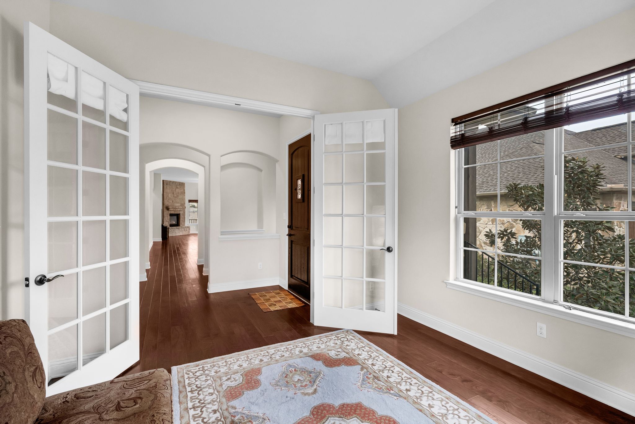 212 Tavish Trail Austin, TX 78738 - Photo 12 of 32 a view of an empty room with wooden floor and a window