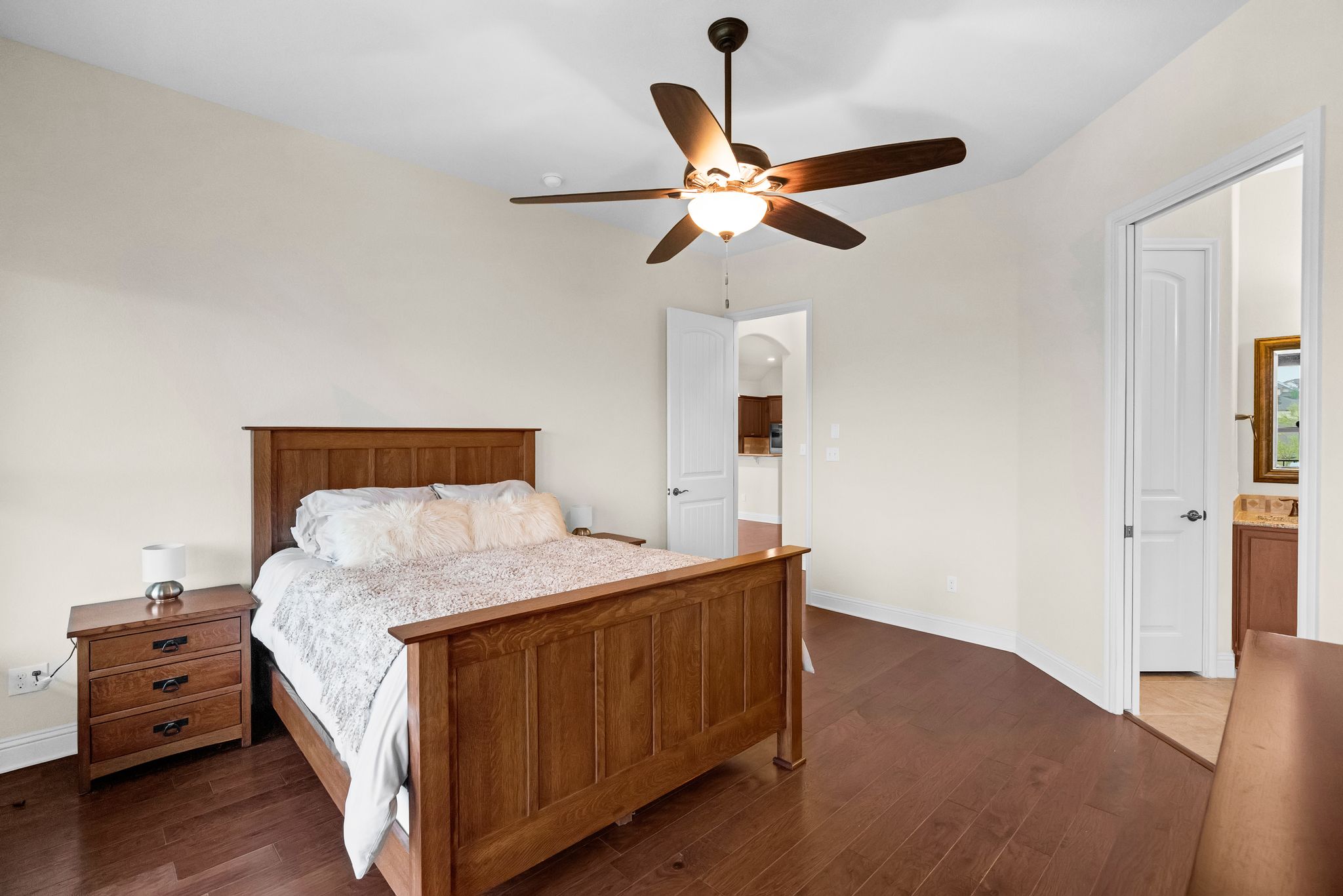 212 Tavish Trail Austin, TX 78738 - Photo 21 of 32 a bedroom with a bed and wooden floor