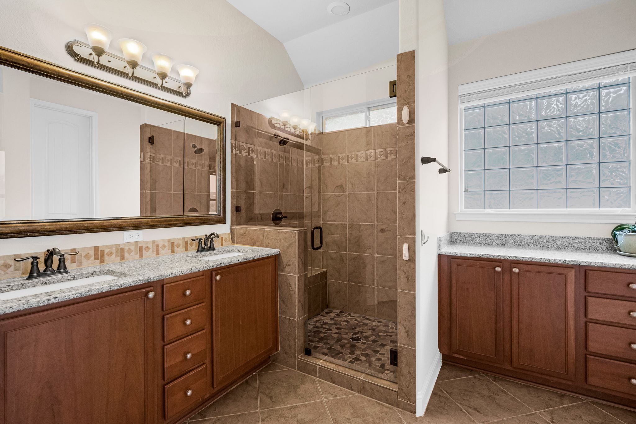 212 Tavish Trail Austin, TX 78738 - Photo 23 of 32 a bathroom with a double vanity sink mirror and shower