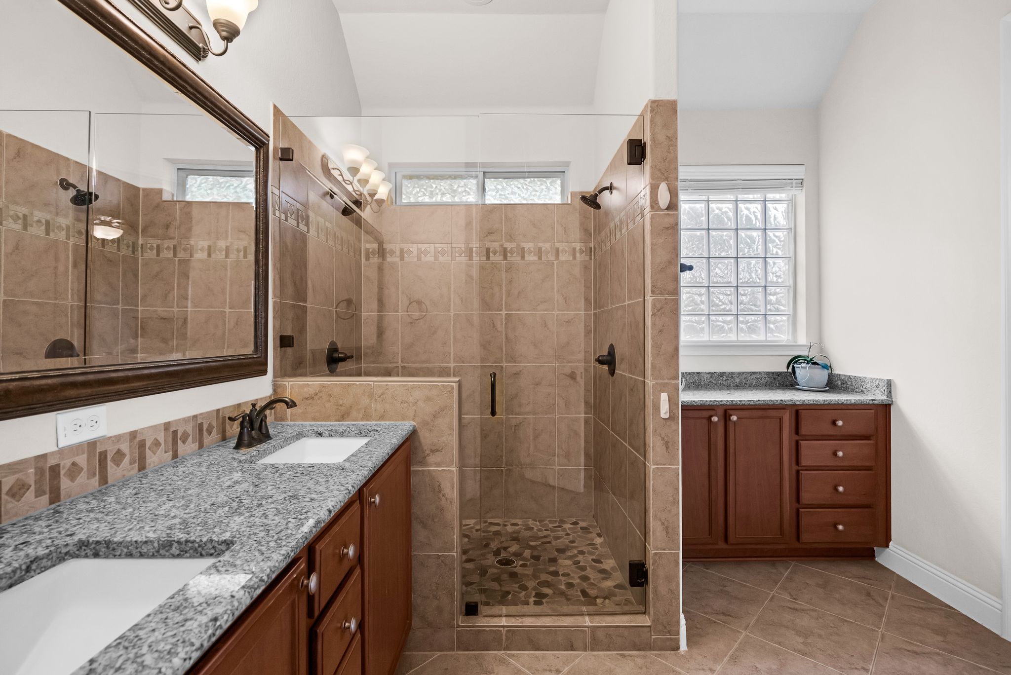 212 Tavish Trail Austin, TX 78738 - Photo 24 of 32 a bathroom with a granite countertop sink a mirror and shower