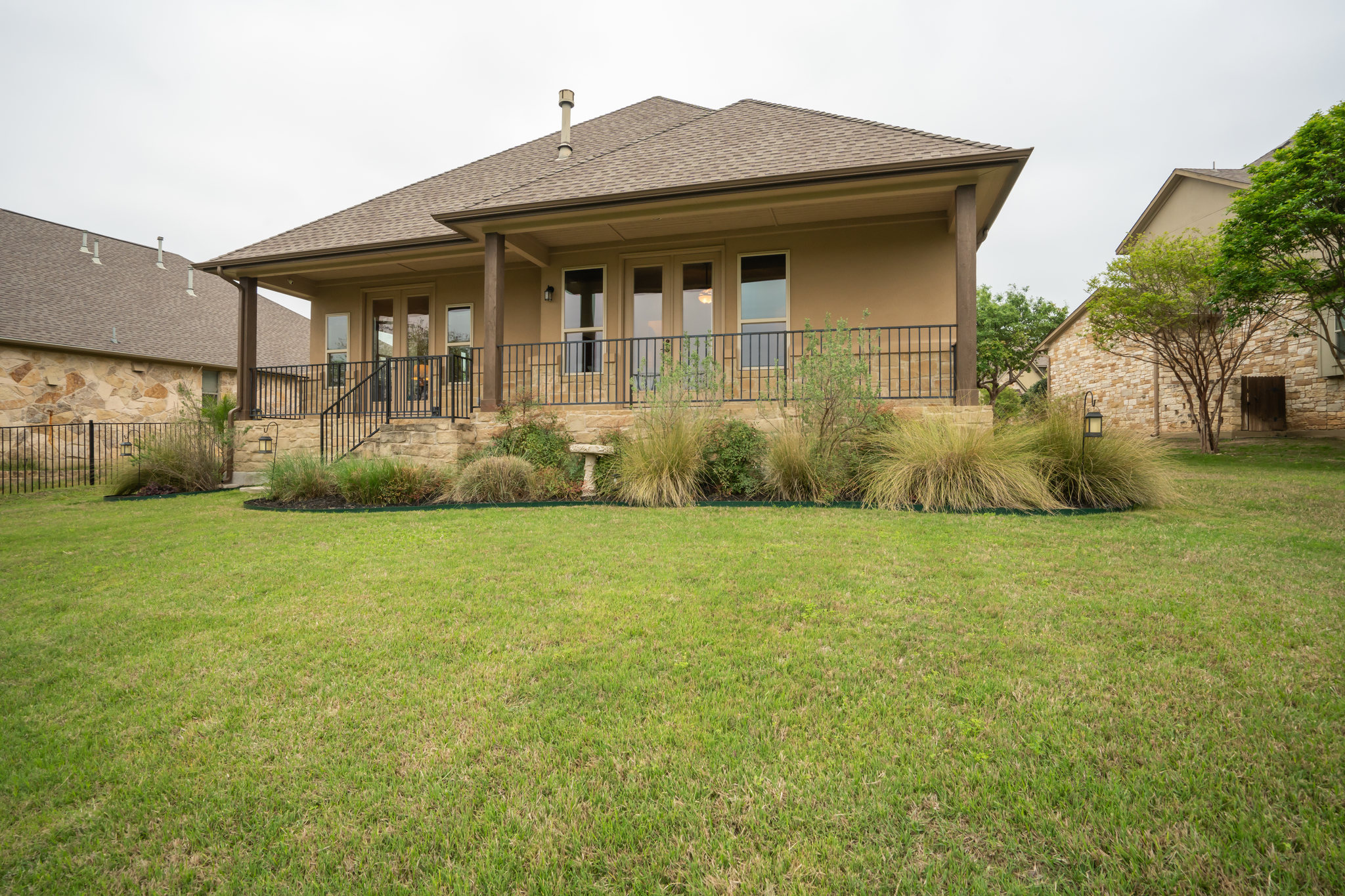 212 Tavish Trail Austin, TX 78738 - Photo 29 of 32 a front view of a house with garden