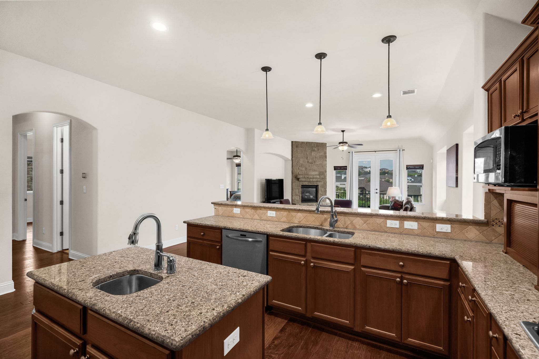 212 Tavish Trail Austin, TX 78738 - Photo 7 of 32 a kitchen with granite countertop a sink and a stove