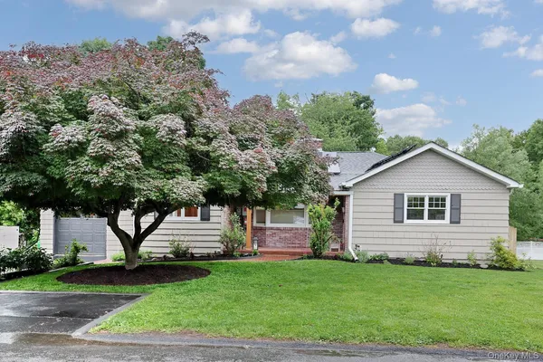a front view of a house with a garden