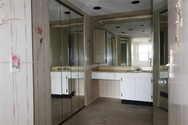 a white toilet sitting next to a bathroom sink