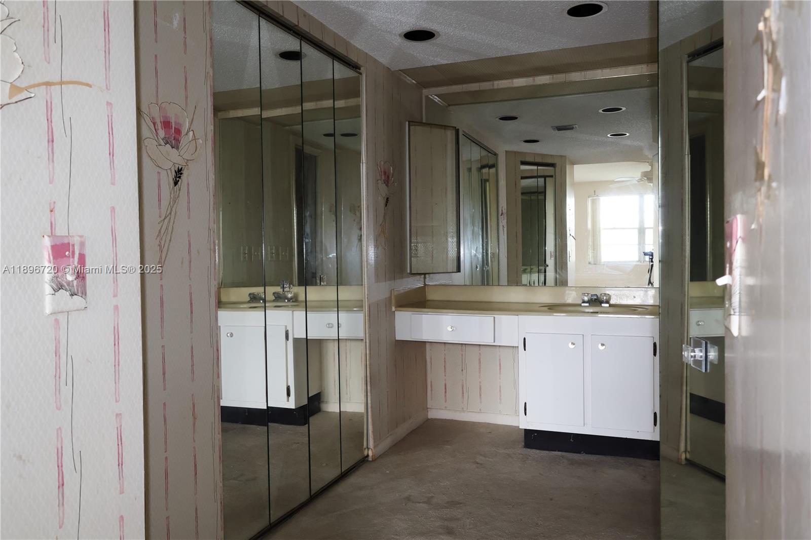 1705 Andros Isle, Unit E3 Coconut Creek, FL 33066 - Photo 13 of 17 a bathroom with a double vanity sink and mirror