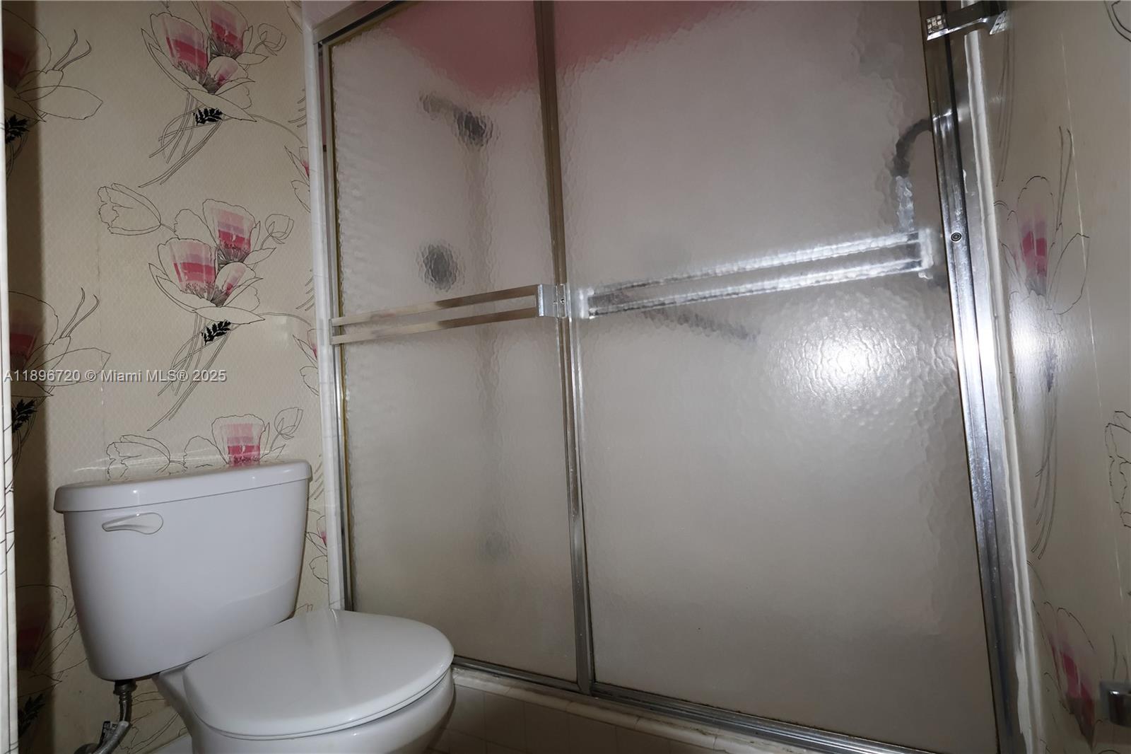 1705 Andros Isle, Unit E3 Coconut Creek, FL 33066 - Photo 14 of 17 a white toilet sitting next to a bathroom sink