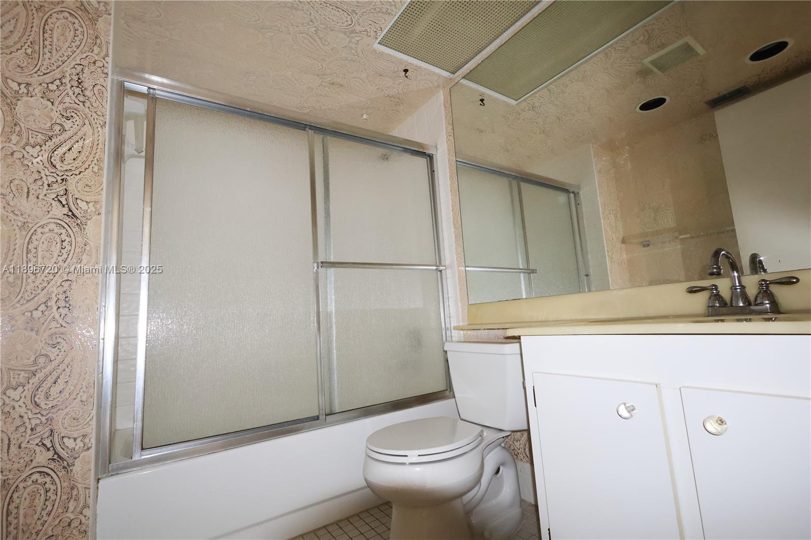 1705 Andros Isle, Unit E3 Coconut Creek, FL 33066 - Photo 17 of 17 a bathroom with a granite countertop sink toilet and shower