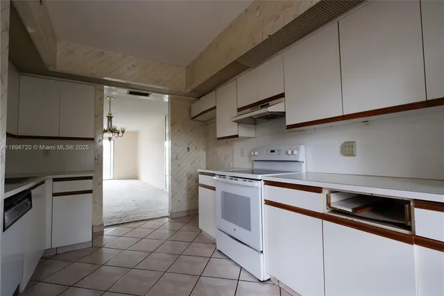 a kitchen with stainless steel appliances granite countertop a sink and a stove