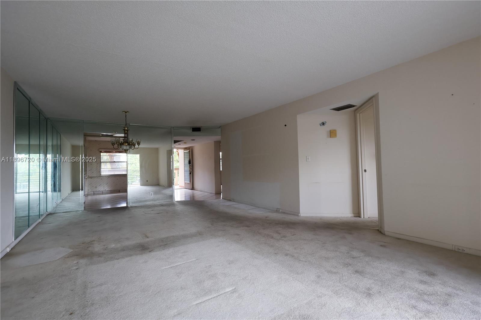 1705 Andros Isle, Unit E3 Coconut Creek, FL 33066 - Photo 7 of 17 a view of a livingroom with an empty space and a window
