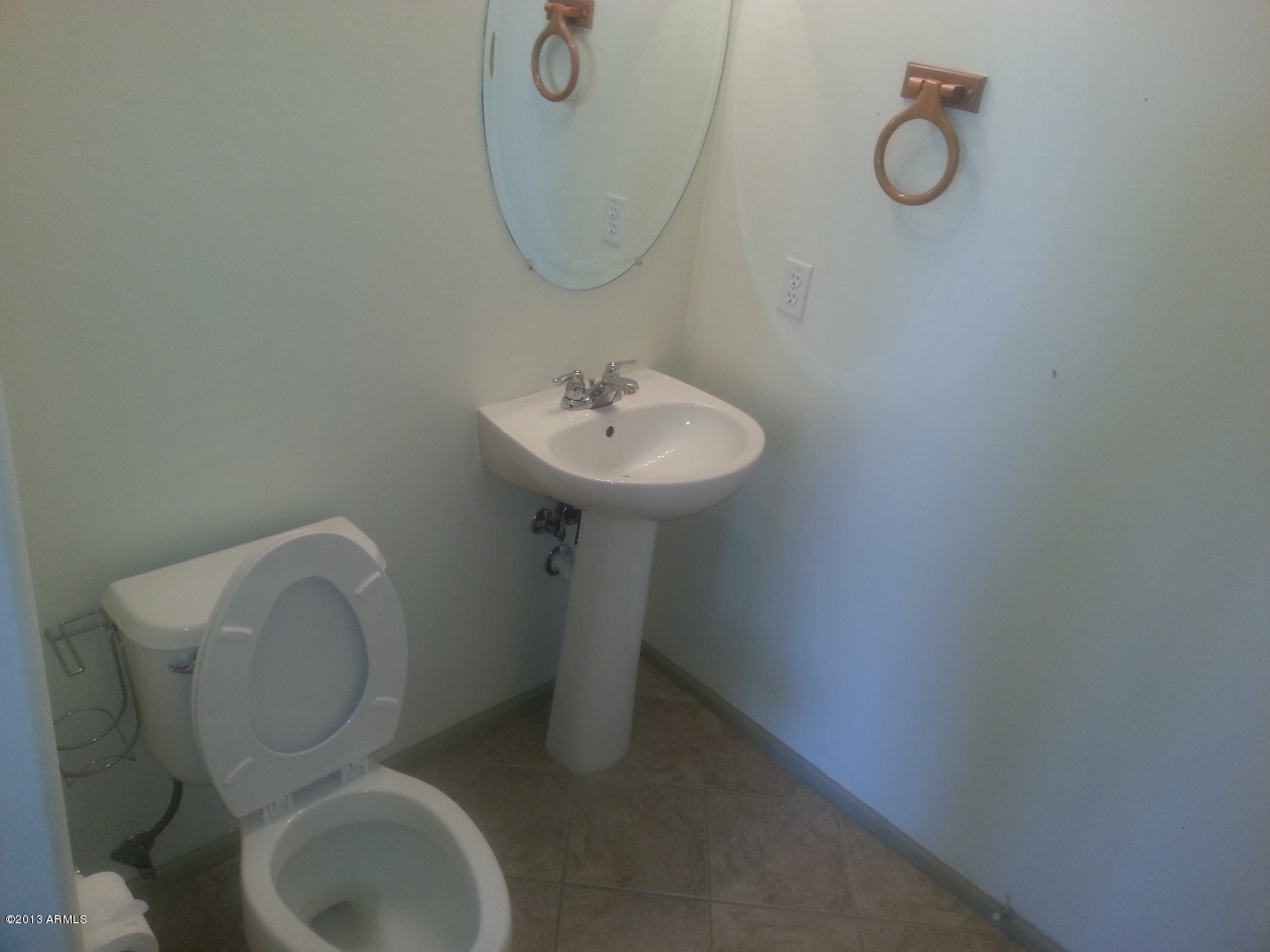 44395 Cypress Lane Maricopa, AZ 85138 - Photo 11 of 20 a bathroom with a toilet sink and mirror