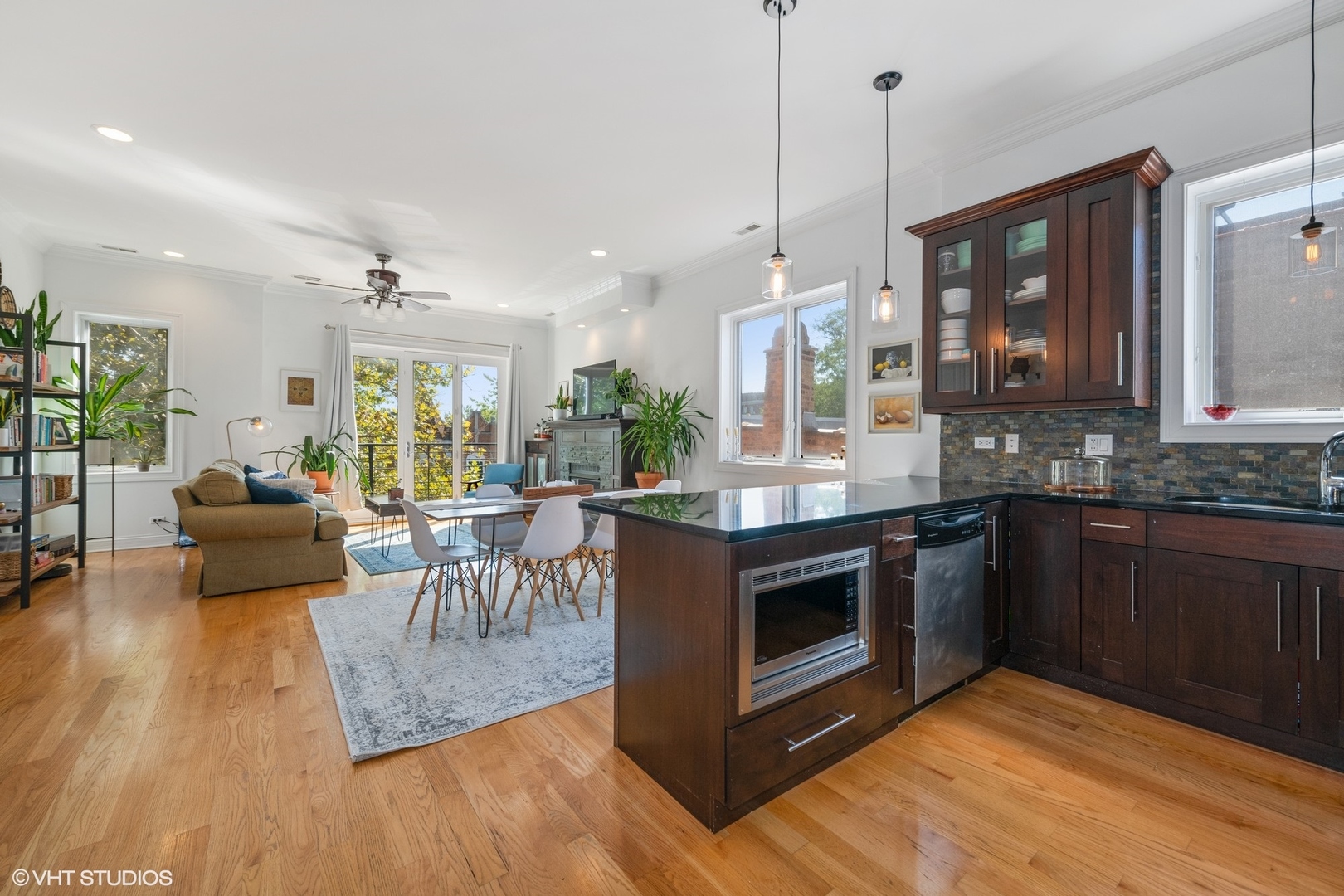 2642 West Cortez Street, Unit 3 Chicago, IL 60622 - Photo 10 of 19 a kitchen with stainless steel appliances granite countertop a stove top oven a sink dishwasher a dining table and chairs with wooden floor