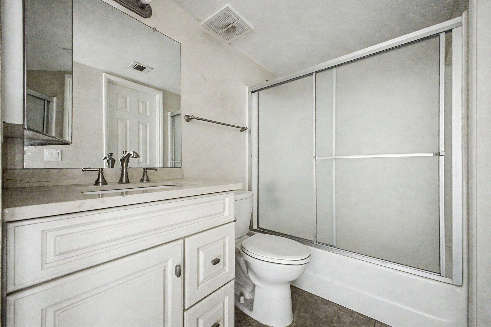 1720 East Thunderbird Road, Unit 1086 Phoenix, AZ 85022 - Photo 11 of 32 a bathroom with a toilet a sink and shower