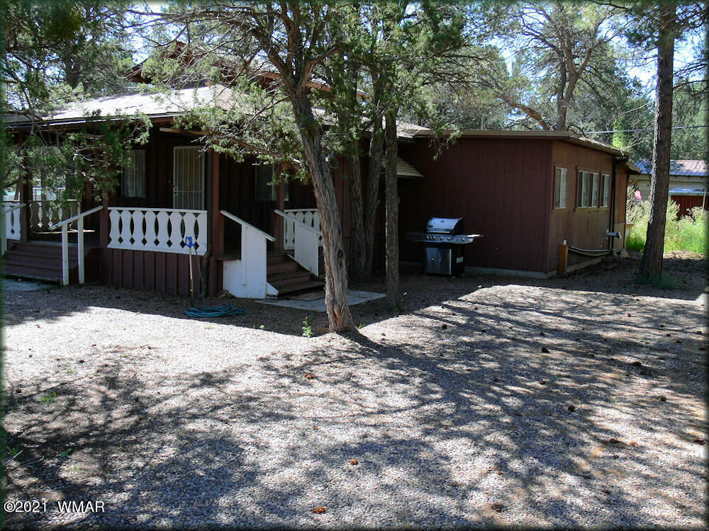 2179 Chevelon Road Overgaard, AZ 85933 - Photo 2 of 11 a street view with wooden fence and a bench