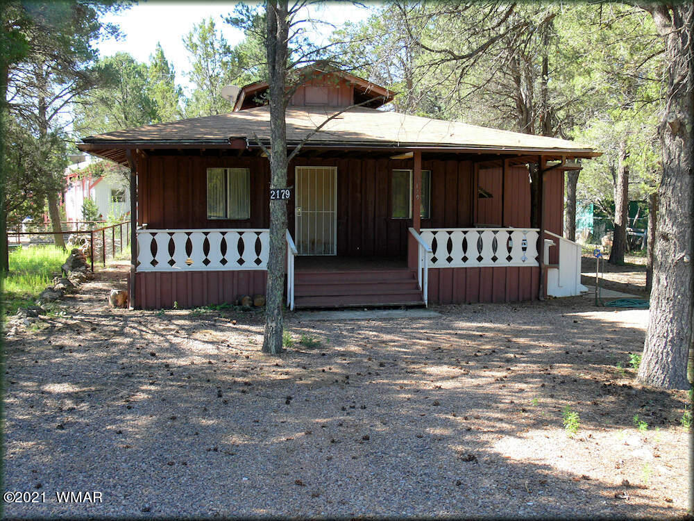 2179 Chevelon Road Overgaard, AZ 85933 - Photo 5 of 11 a front view of a house with a yard