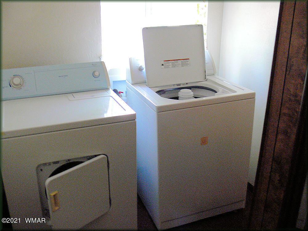2179 Chevelon Road Overgaard, AZ 85933 - Photo 8 of 11 a utility room with dryer and washer