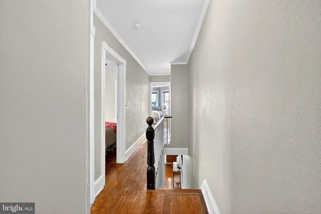 a view of hallway with wooden floor