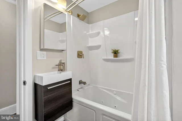 a bathroom with a bathtub a sink and a shower