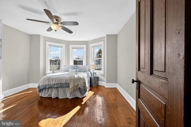 a spacious bedroom with a bed and a chandelier