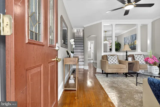 a living room with furniture and a chandelier