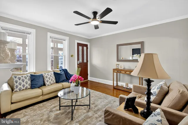 a living room with furniture or couch and a ceiling fan