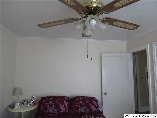 530 Newman Springs Road Lincroft, NJ 07738 - Photo 12 of 21 a bedroom with a bed and a chandelier fan