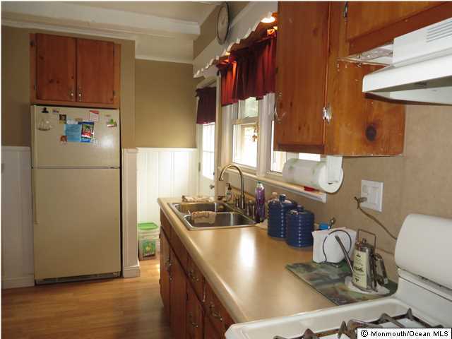 530 Newman Springs Road Lincroft, NJ 07738 - Photo 3 of 21 a kitchen with a refrigerator and a sink