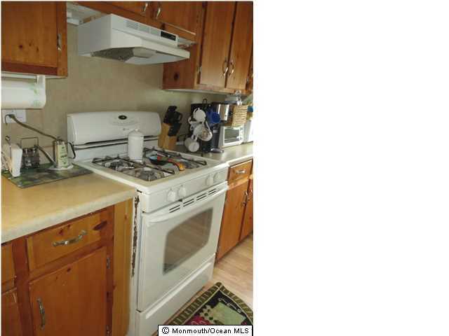 530 Newman Springs Road Lincroft, NJ 07738 - Photo 6 of 21 a kitchen with a stove and cabinets