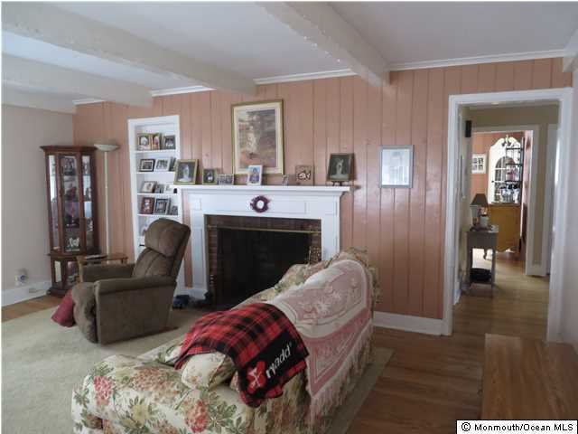 530 Newman Springs Road Lincroft, NJ 07738 - Photo 7 of 21 a living room with furniture and a fireplace