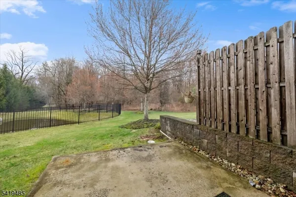 a view of a backyard with wooden fence