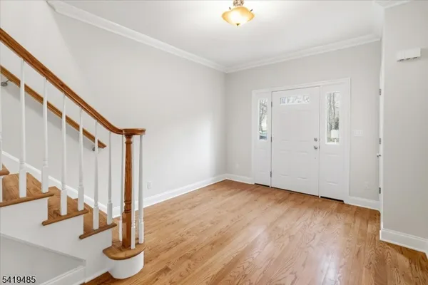 a view of an entryway with wooden floor