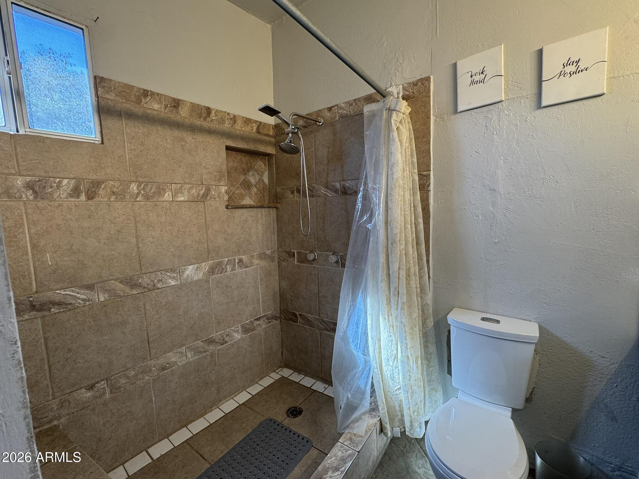 3140 West Osborn Road, Unit 8 Phoenix, AZ 85017 - Photo 11 of 13 a bathroom with a toilet and a shower