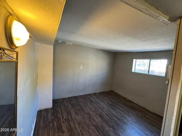 a view of a room with wooden floor and a window