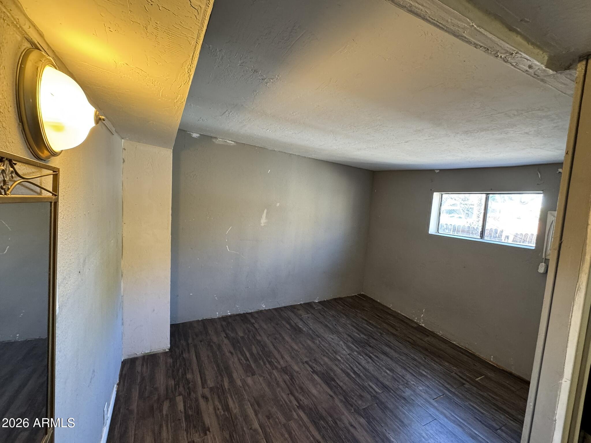 3140 West Osborn Road, Unit 8 Phoenix, AZ 85017 - Photo 5 of 13 a view of a room with wooden floor and a window