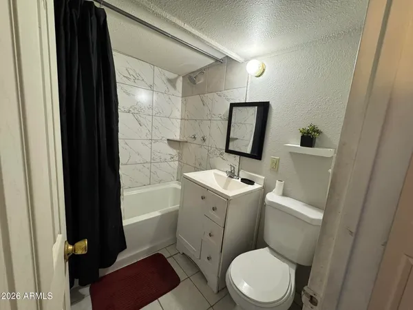 a bathroom with a toilet a sink and bathtub