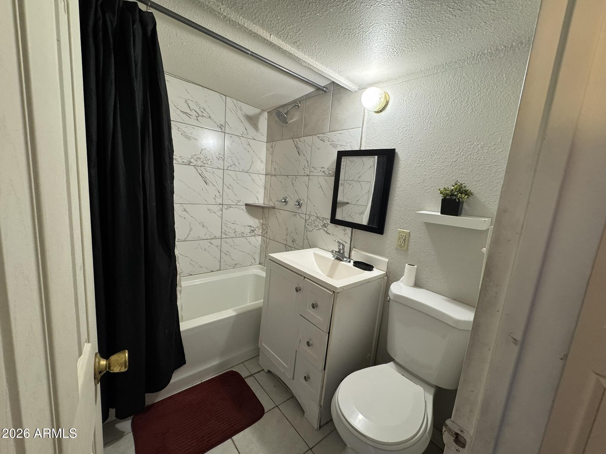 3140 West Osborn Road, Unit 8 Phoenix, AZ 85017 - Photo 6 of 13 a bathroom with a toilet a sink and bathtub