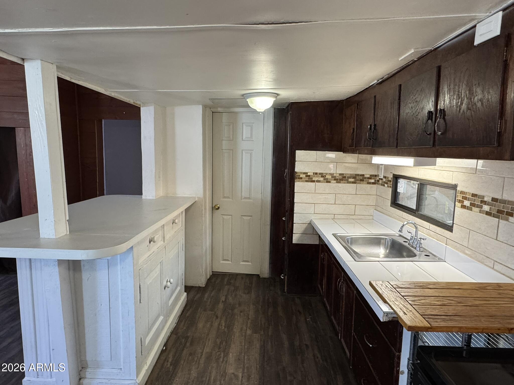3140 West Osborn Road, Unit 8 Phoenix, AZ 85017 - Photo 9 of 13 a kitchen with granite countertop a sink a stove refrigerator and cabinets