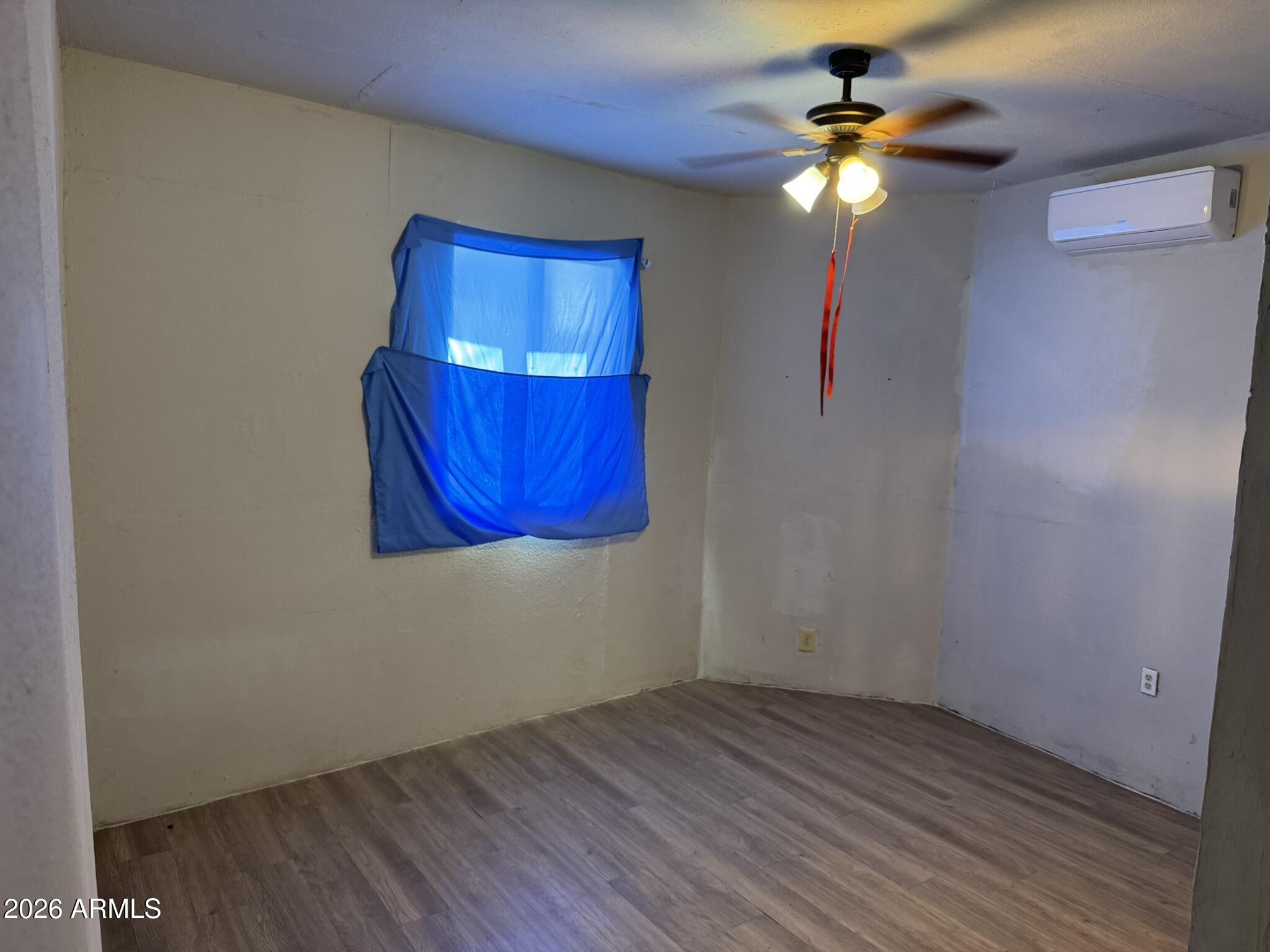3140 West Osborn Road, Unit 8 Phoenix, AZ 85017 - Photo 10 of 13 a view of empty room with wooden floor