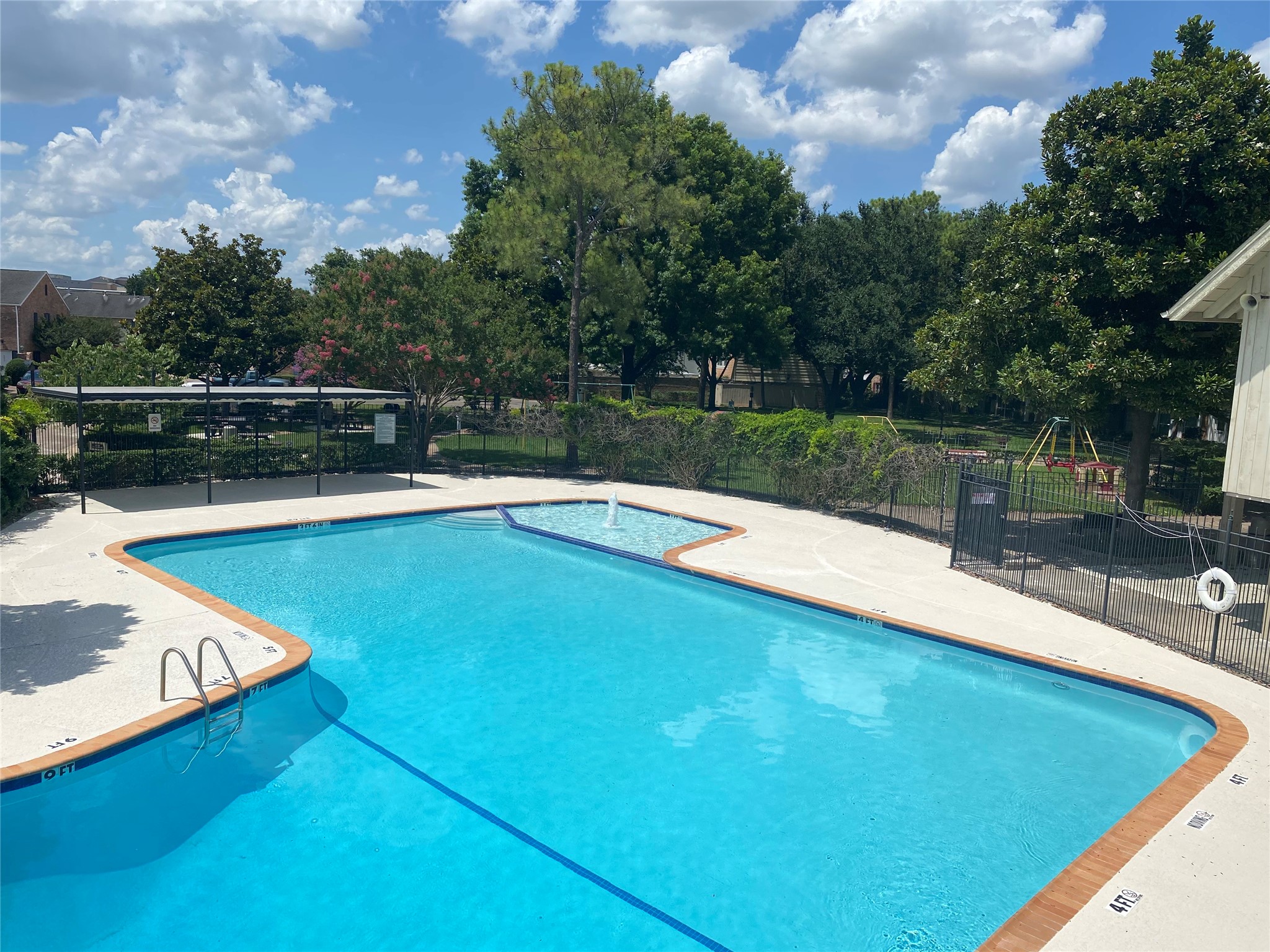 6452 Burgoyne Road, Unit 100 Houston, TX 77057 - Photo 40 of 44 a view of a swimming pool with a patio and a yard