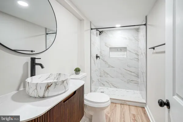 a bathroom with a shower a toilet and a mirror