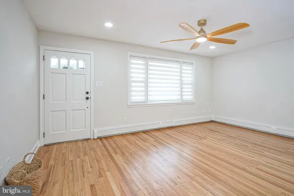 a kitchen with cabinets stainless steel appliances a sink and wooden floor
