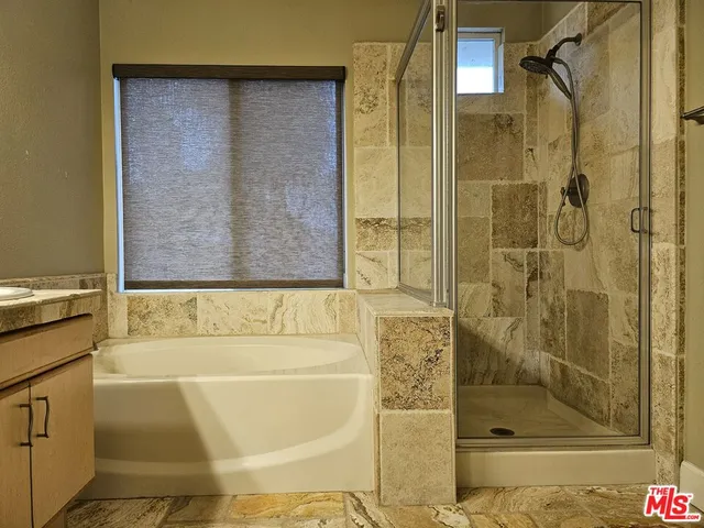 a bathroom with a bathtub and shower