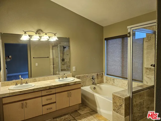 a bathroom with a tub sink and mirror