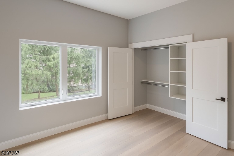 391 Springfield Avenue, Unit 3J Berkeley Heights, NJ 07922 - Photo 4 of 9 a view of an empty room with a window