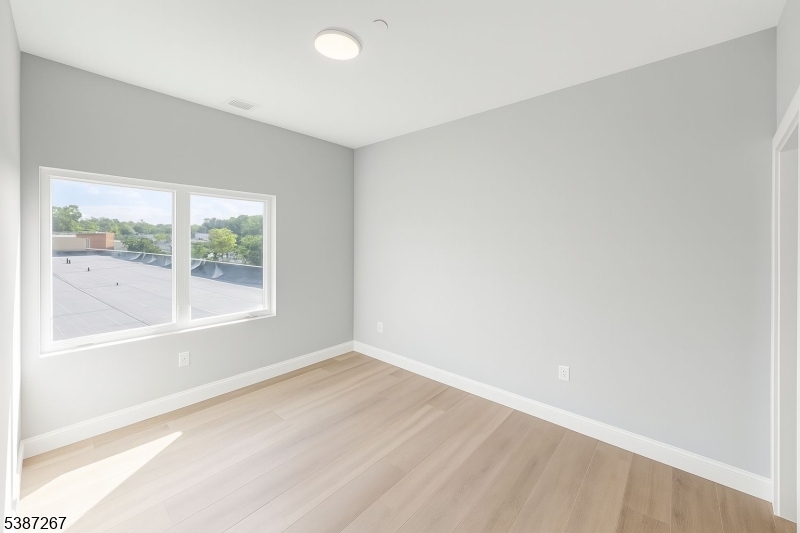 391 Springfield Avenue, Unit 3J Berkeley Heights, NJ 07922 - Photo 7 of 9 a view of an empty room with a window